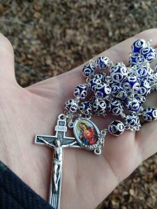 Blue and silver rosary with Sacred Heart medal.