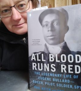 Me with a copy of All Blood Runs Red, a biography of Eugene Ballard by Phil Keith and Tom Clavin